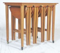 A retro vintage 1970's danish inspired drop leaf teak veneered quartetto nest of tables featuring