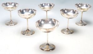 A set of 6 hallmarked Sterling Silver Champagne / Martini glasses / goblets, the bowls raised on a