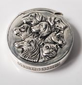 A silver plated vesta case of circular form with an embossed image of various breeds of dogs and