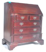 A 20th Century Georgian revival mahogany bureau with drop front and appointed sectional interior