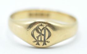 A late 19th / early 20th Century 18ct gold signet ring having a round head engraved with initials.