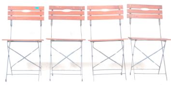 A set of four vintage 20th century French folding cafe chairs with painted banded metal frames and