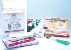 A collection of artist paints and materials to include artists paper, gouache paint, oil paints,