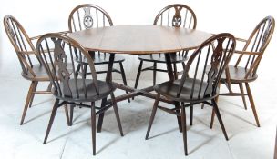 An vintage retro 20th Century Ercol elm golden dawn dining table and chairs having a round topped