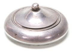 A silver hallmarked powder compact lidded pot having glass and silver body with silver lid