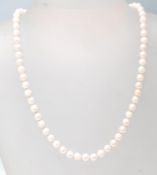 A hallmarked 9ct gold ladies cultured pearl necklace having a strand of spherical pearls set with