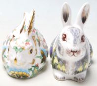 A pair of Royal Crown Derby paperweights both in the shape of rabbits including Springtime Bunny &
