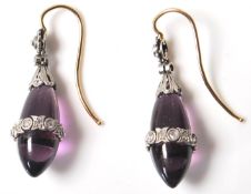 A pair of early 20th Century Edwardian amethyst and diamond drop earrings having polished amethyst