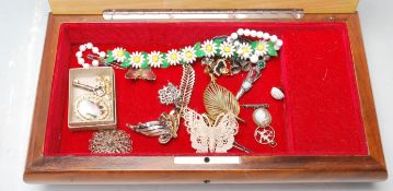 A collection of antique and vintage costume jewellery including a cameo brooch, silver siam bell
