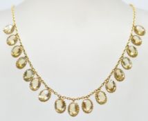 A 20th Century antique 15ct gold and citrine necklace having a fine chain with seventeen oval cut