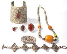 A selection of 20th Century North African white metal jewellery to include a beaded necklace