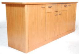A retro vintage mid 20th Century Danish inspired teak sideboard credenza having shaped edges over