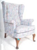 A mid century 1950's wingback armchair Parker Knoll Model PK 720 / 1 raised on cabriole legs on