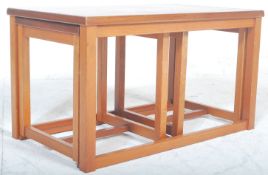 A vintage retro 20th century Danish inspired unusual teak wood nest of tables in the manner of