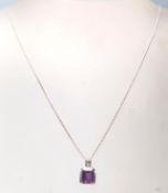 A hallmarked 18ct white gold pendant necklace having a fine snake chain with a square pendant