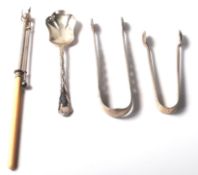 A selection of 20th Century silver hallmarked items to include a pair of sugar tong with engraved