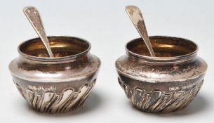 A pair of silver hallmarked table cruets / salt cellars of tapering form having gadrooned decoration