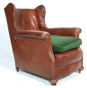 An early 20th century, circa 1930's club / chesterfield wing back armchair / club chair. The chair
