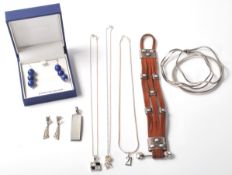 A collection of silver jewellery to include a stamped 925 silver bangle, a stamped 925 wave form