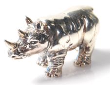 A Sterling silver cast figure of a rhinoceros. Stamped Sterling to the base. Weighs 19g. Measures