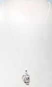 A stamped .925 silver necklace having a .925 silver pendant in the form of an owl perched on a