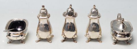 A set of 1930’s Adie Brother's silver condiments set to include three salt and paper shakers
