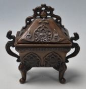 A vintage 20th Century bronze Chinese censer having a pierced lid over a finely decorated body