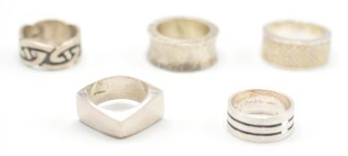 A collection of five gentleman's silver rings to include a celtic knot style ring, a large