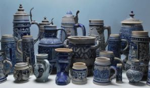 A collection of 20th Century German ceramic stein drinking glasses, each having raised decoration to