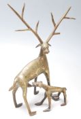 A 20th Century Indian folk art cast brass figurine of a horn deer suckling a fawn with incised