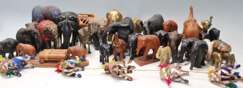 A large collection of vintage 20th century hand carved wooden elephants of various sizes having hand