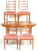 A vintage retro 20th century Danish influenced teak wood extending dining table with four dining