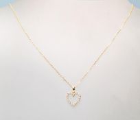 An 18ct ladies necklace having a heart shaped pendant set with diamond accent stones on a 18ct cable