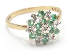 A hallmarked 9ct gold green and white stone cluster ring having a round cluster of green and white