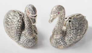 A pair of 20th Century silver plated salt and pepper condiments in the form of swans, each having