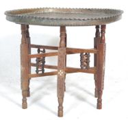 An early 20th Century antique tray opium table raised on six fruit wood legs united by stretchers