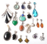 A collection of mixed vintage silver mounted pendants, most being set with coloured stones to