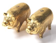 A pair of 18ct gold plated salt and pepper shakers in the shape of pot bellied pigs. Stamped 18ct