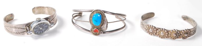 A group of three native American Navajo silver bangle bracelets to include one split band bangle