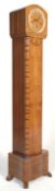An Art Deco 1930's figured walnut grandmother clock. The Art Deco case having a silvered chapter