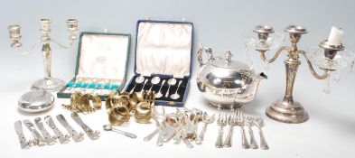 A collection of 20th Century silver plated wares to include a two branch armed candlesticks, two