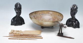 A collection of vintage tribal artefacts including an ashanti bronze in the shape of a bird, a