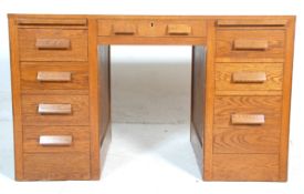 A 1930's Industrial golden oak  twin pedestal office. The desk having a wooden desktop with two pull