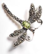A stamped .925 silver and marcasite ladies dress brooch in the form of a dragonfly with a central