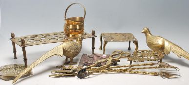 A good collection of antique 20th Century brass items to include French brass trivets stand with