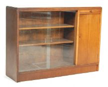 A vintage retro 20th century oak bookcase cabinet with twin glass sliding doors and adjustable