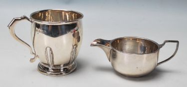 Pa pair of English silver hallmarked creamer jugs. One with circular pedestal base and Art Deco