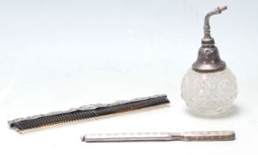 A ladies early 20th Century dressing table comb having a repousse decoration collar to the top