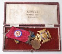 A pair of early 20th century Masonic 9ct gold and enamel medals presented to Bro. H. W. Wedlock 23