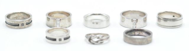A group of eight silver rings to include mostly wide band rings including two set with square cut